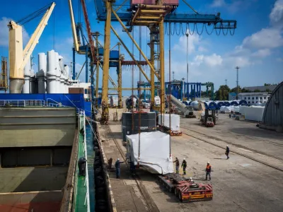 Crated units loaded into the hold under port cranes