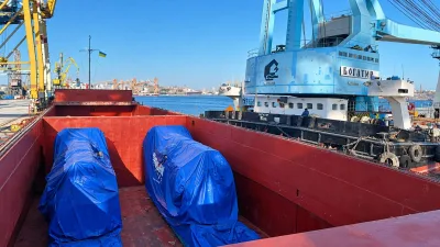 Tarpaulin-covered cargo secured in the hold
